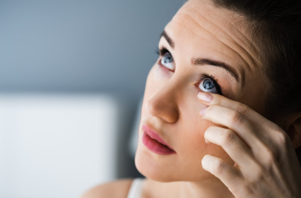 Women touching eyes due to experience of dry eyes