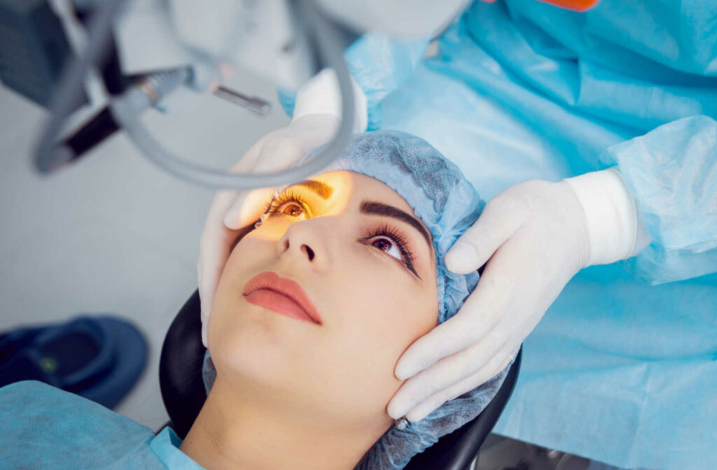 Surgeon adjusting a female patient under the laser.