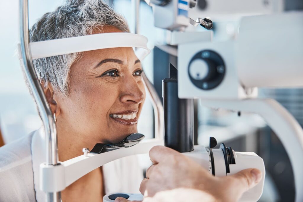 Happy older woman getting an eye exam.