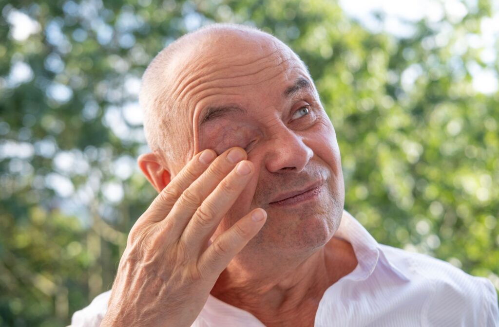 A man rubbing his eyes due to discomfort caused by an eye condition.