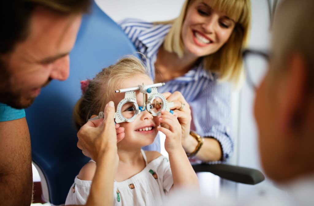 A smiling child gets an eye exam to determine if they have myopia.