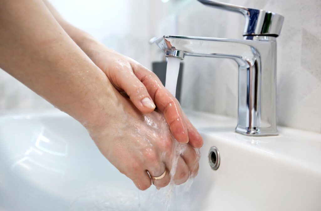 Close-up image of someone washing their hands.